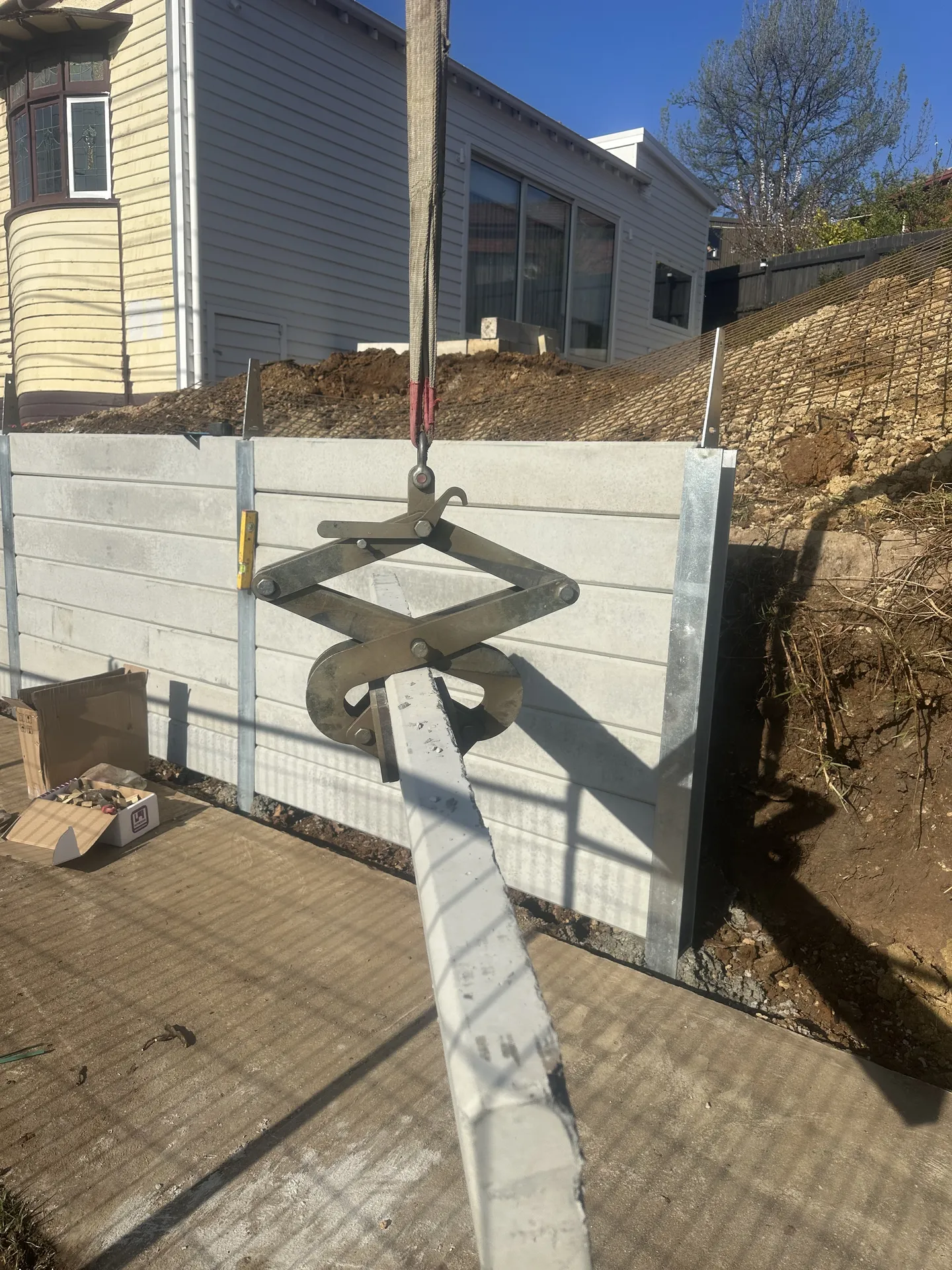 Concrete sleeper being craned into position